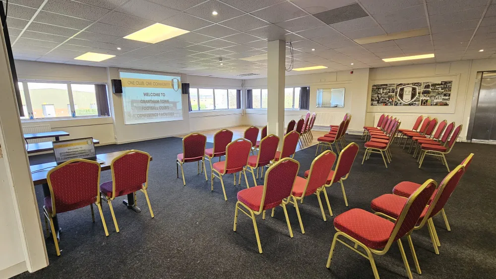 Conference room arranged in lecture style with rows of chairs facing the front at The Gingerbread